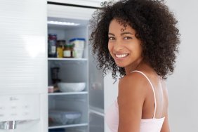 woman looking in refrigerator