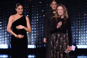 Clare Waight Keller is watched by Meghan, Duchess of Sussex and Rosamund Pike as she speaks on stage after receiving the award for British Designer of the Year Womenswear Award for Givenchy during The Fashion Awards 2018 In Partnership With Swarovski at Royal Albert Hall on December 10, 2018 in London, England.